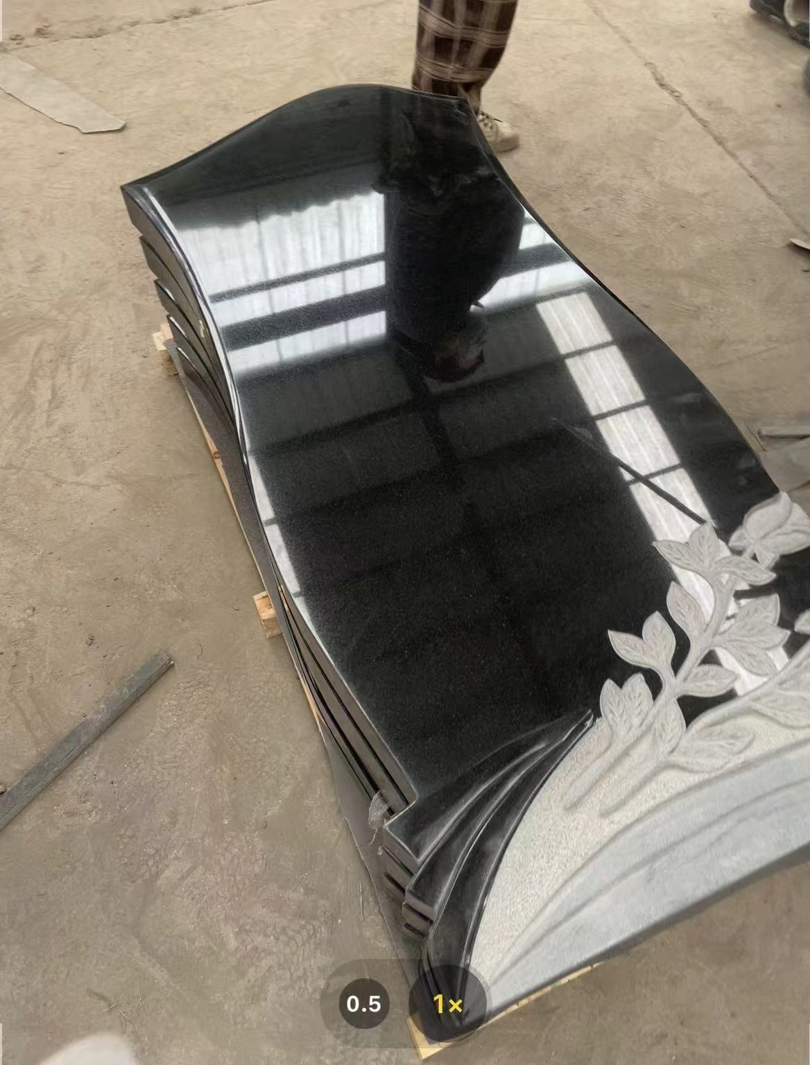 extremely gloss black granite headstone with white carved flowers.jpg