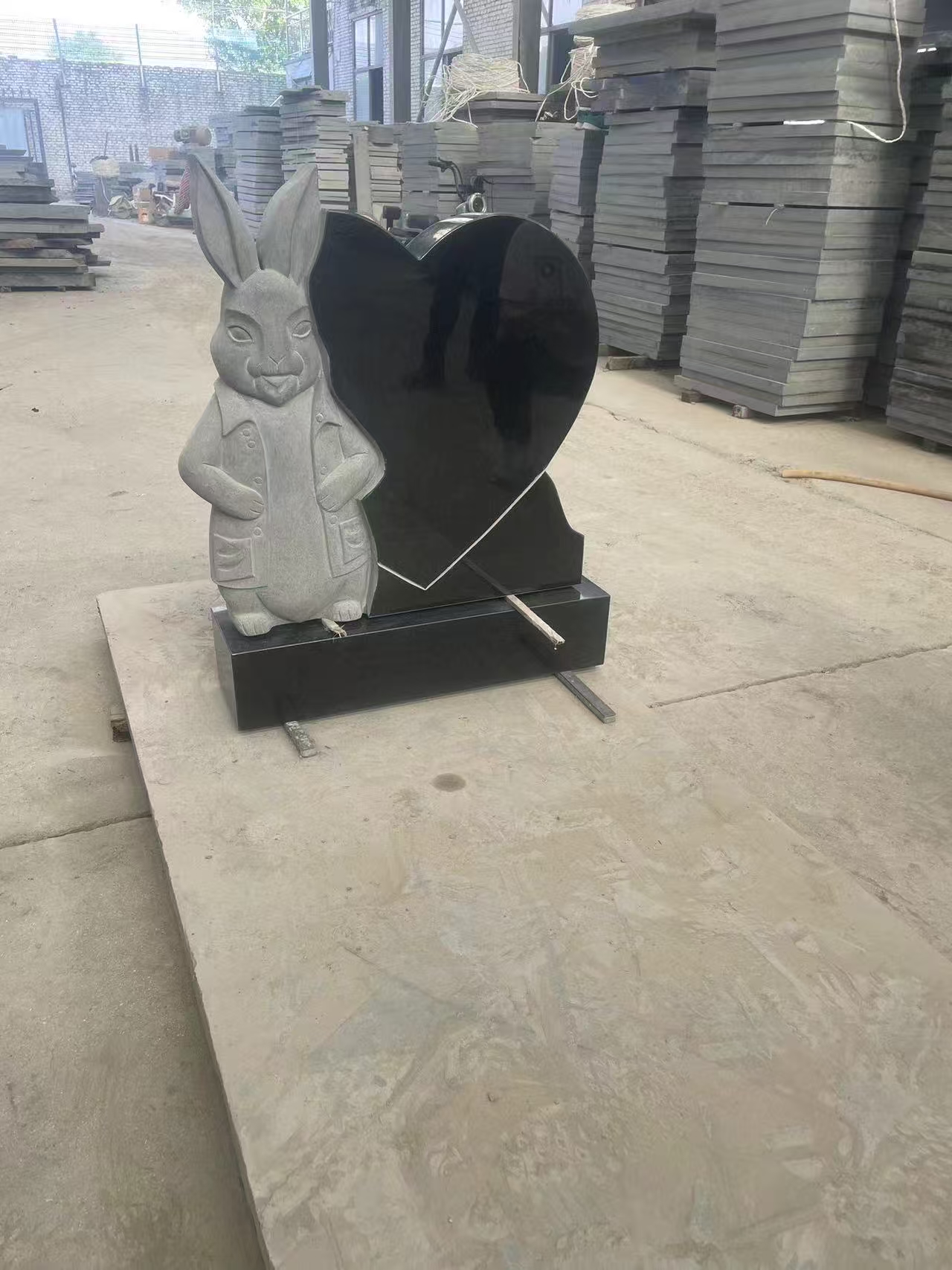 black granite heart-shape headstone with rabbit statue.jpg