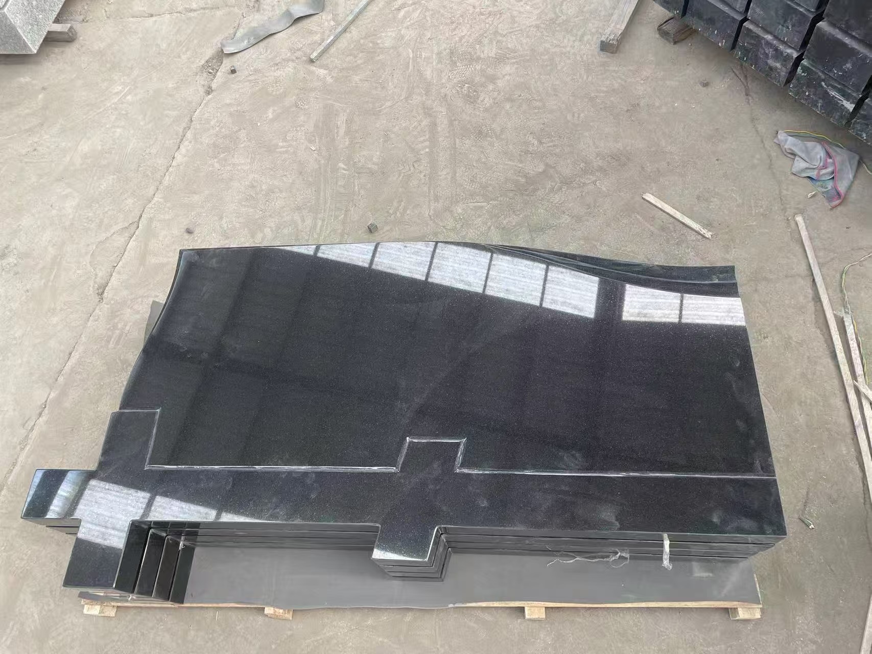 extremely gloss black granite headstone with cross carved.jpg